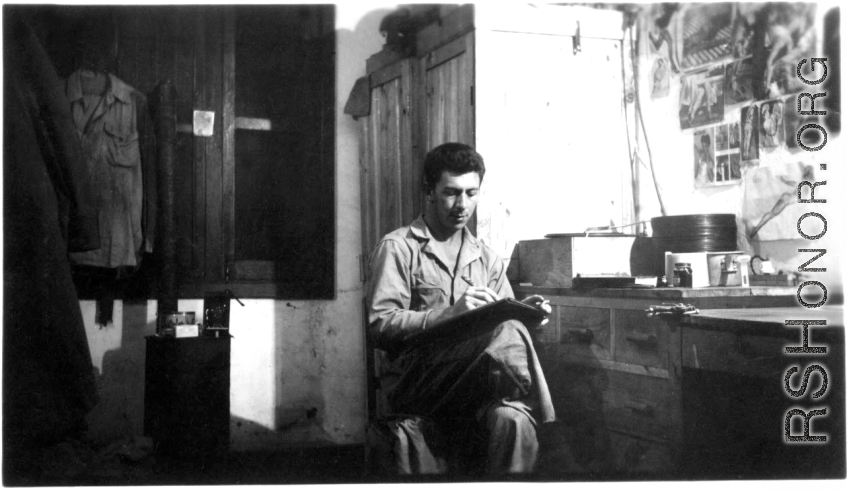 Fernand Arel, writing in the barracks, in with Daggett and Bates, Yangkai, China July 1944.