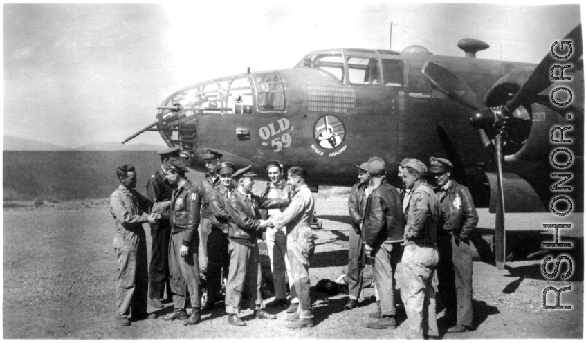 Left-right, William 'Bill' Byran shakes hands with Capt Robert Ebey (pilot), who hides Capt William DeVries (engineering officer) , Lt. Hilliard Ebey (nav), Lt Paul Sjoberg (copilot), Lt George Jernigan (bombardier) shakes hands with M/Sgt Cecil ' Bo' Noe (line chief) with Sgt Donnely (radio) looking on, S/Sgt Lyle Wilson, Pete Bertani, unknown, Capt Joseph Peterson, S/Sgt Rudolf Madsen (tail gunner).  From the collection of Frank Bates.