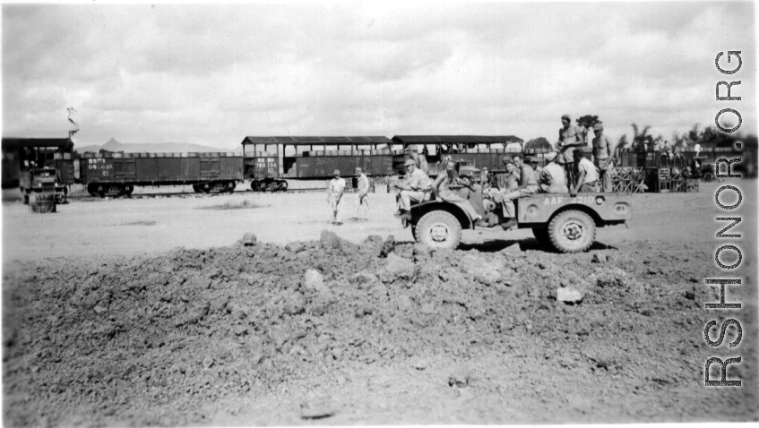 Kealy, Johnny Burns, Schmidt, Hammett, Alexander, Nash, Nyreen, Alelunas, Sam Knox, Liuzhou, September 1944. Train in the background is full of barrels of fuel. The disturbed ground in the foreground is likely caused by bombing.  From the collection of Frank Bates.