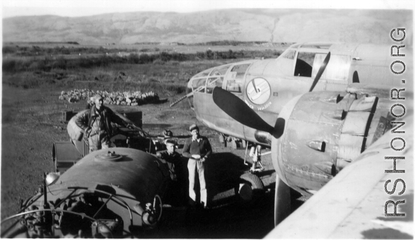 Early in the morning on a spring day in 1945, 491st Bombardment Squadron personnel (mechanics- Schumaier, Scott; armorer- ?) prepare a B-25D, #42, for a mission. The top of the fuel truck is in the foreground of the revetment at Yangkai AB. When the aircraft were dispatched to 'forward operation' bases they were often fueled with hand pumps from 50-gallon drums. Francis Strotman, flight engineer, told of using five-gallon 'jerry cans' to transfer fuel from a C-46 transport to his B-25 in order to have enoug