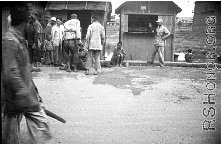 Some commotion around man on ground on street in Yunnan, during WWII.