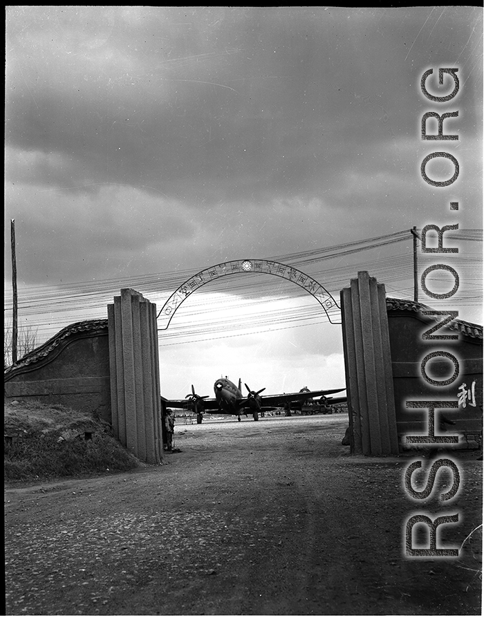 Guarded gates of the Nationalist Kunming Air Force Officer Training School during WWII, with C-46 transports.