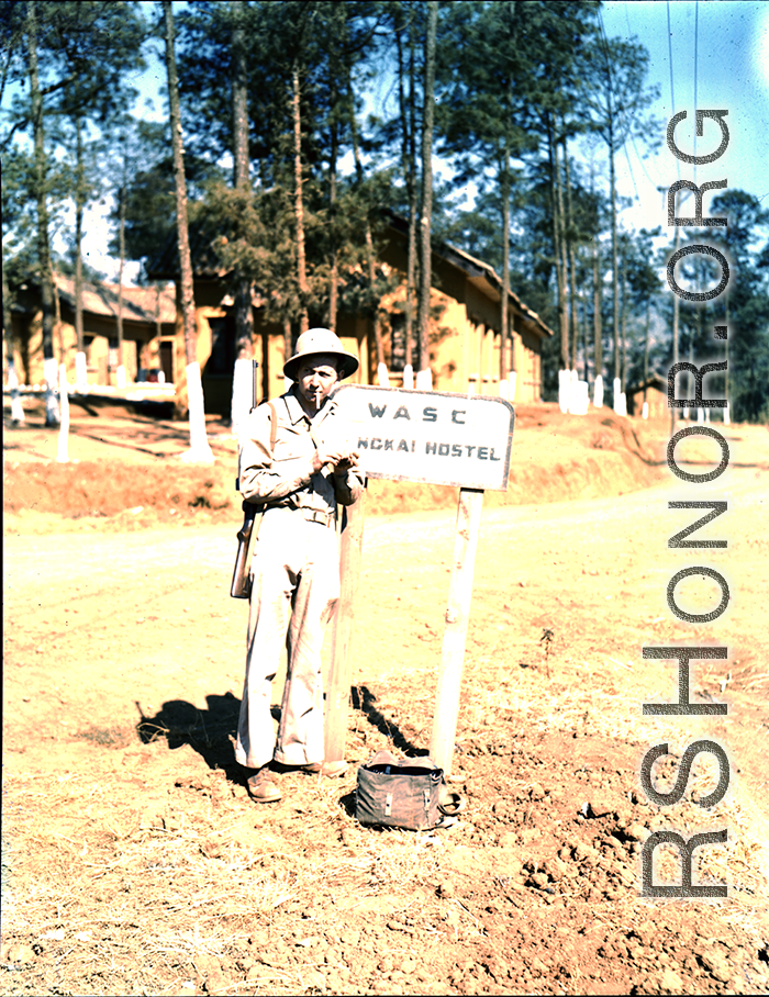 GI stands in front of sign of "WASC Yangkai Hostel" in WWII.