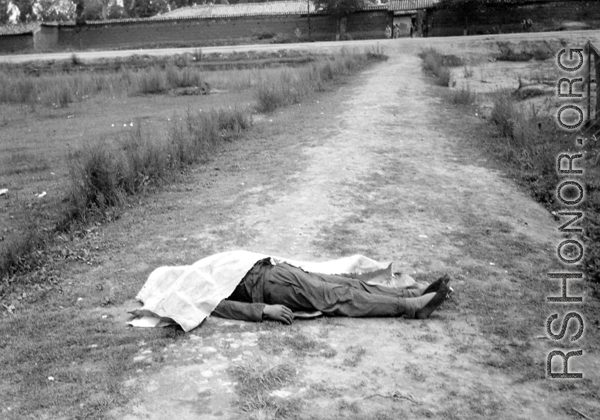 "Yunnan (China), shrouded corpse of houseboy executed for theft." During WWII in SW China. 