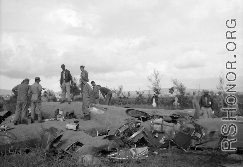 GIs inspect crashed B-24 in a grainfield in China during WWII, between 1943-1945. 