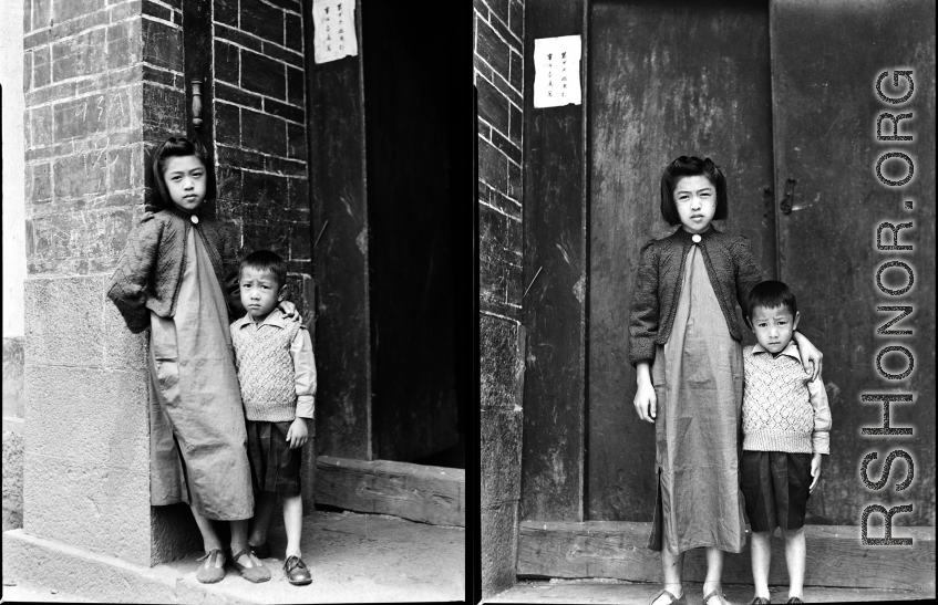 Two elite children from an extremely wealthy family stand in the gate of a elite residence in Yunnan province, that has been appropriated by Nationalist Nationalist 5th Corps forces for military purposes--the white paper posted on the door post says the residence is temporary housing for assistant staff for officers, and HQ for an armored scout unit . The residence compound has its own title, General's Manor (将军第).