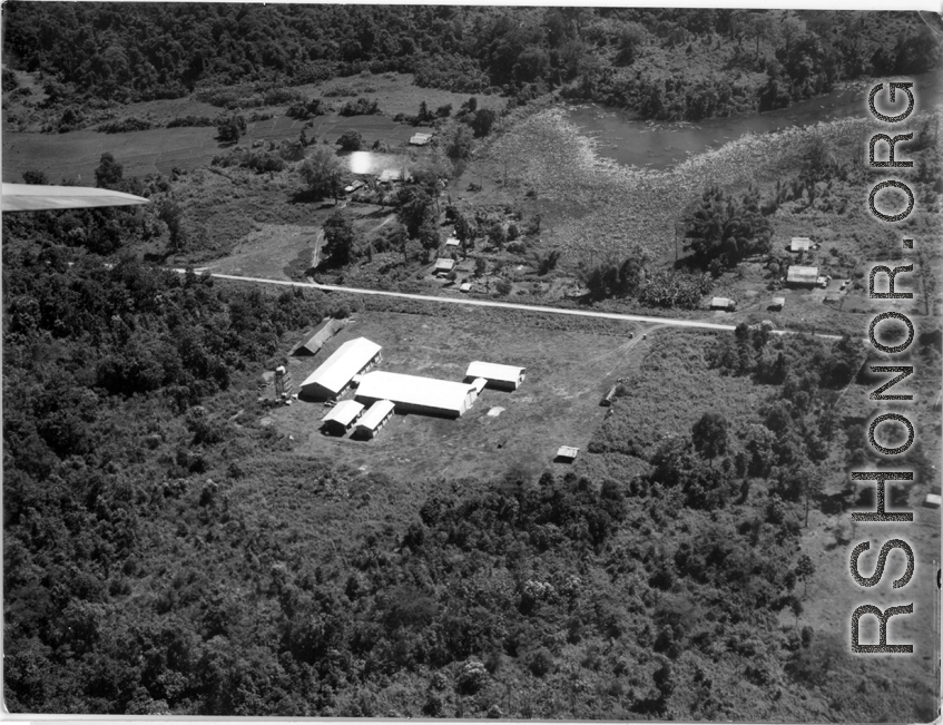 Aerial view of tidy structures on the ground in Burma or French Indochina, in the CBI, during WWII.