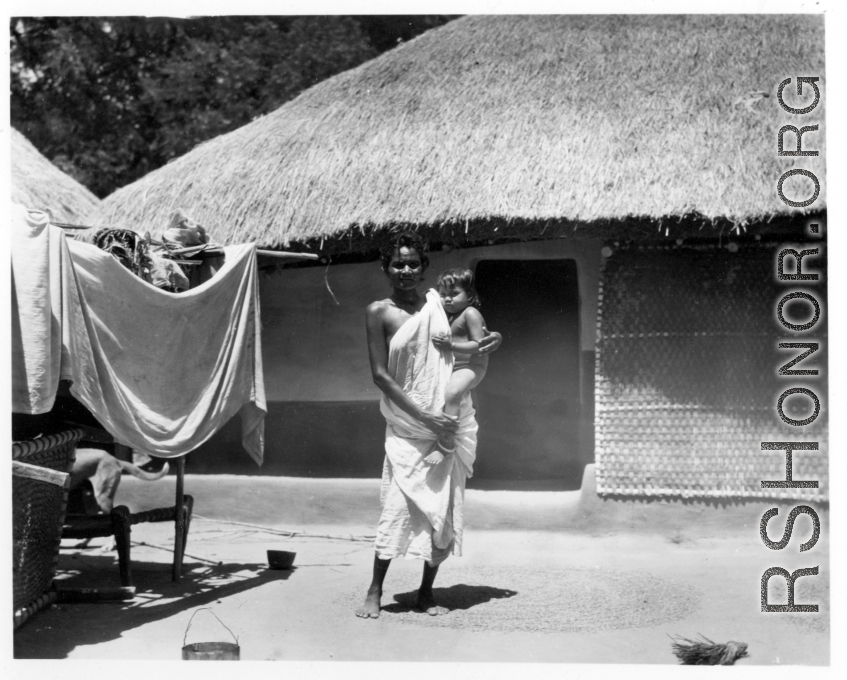 Woman holding child.  Scenes in India witnessed by American GIs during WWII. For many Americans of that era, with their limited experience traveling, the everyday sights and sounds overseas were new, intriguing, and photo worthy.