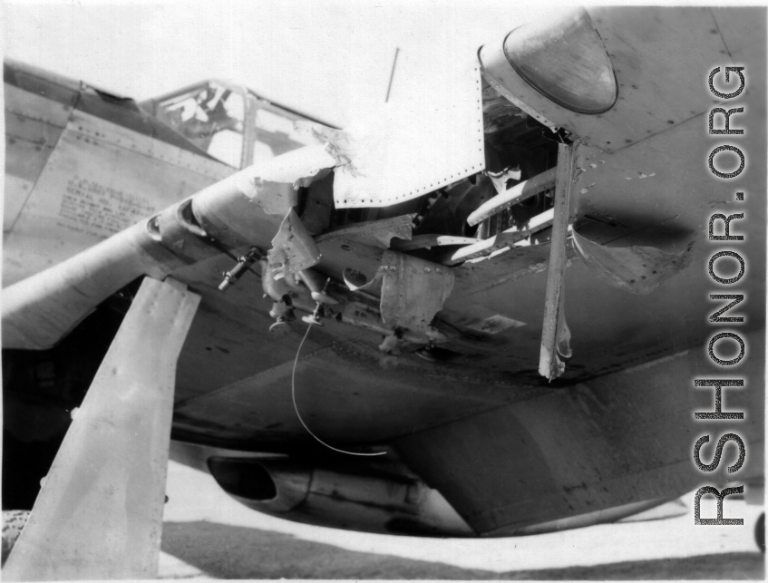 Damage to the forward edge of a wing of a P-51 fighter plane in the CBI during WWII.