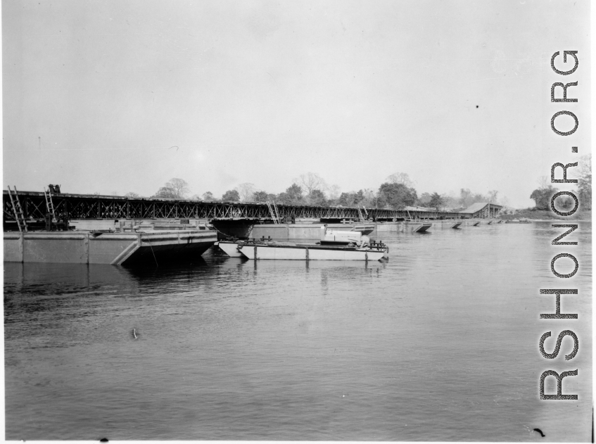 797th Engineer Forestry Company in Burma: Enormous floating bridge over a river on the Burma Road.  During WWII.