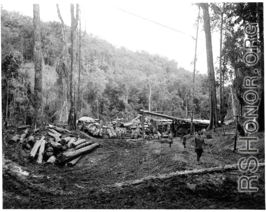 Site at the mill yard, including wranging logs towards saw with cant hooks at a lumber mill of the 797th Engineer Forestry Company in Burma.  During WWII.