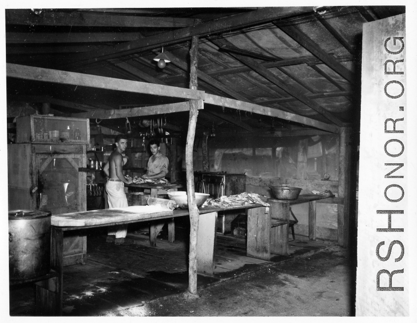 GIs working in a kitchen in a camp in Burma.  During WWII.  797th Engineer Forestry Company.