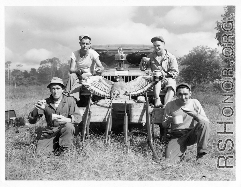 Engineers of the 797th Engineer Forestry Company pose with their catch after a round of huntin' bird in Burma.  During WWII.