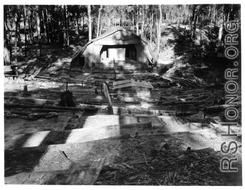 Outdoor amphitheater for 797th Engineer Forestry Company, in Burma, built into circular hillside, with logs for seats.  During WWII.
