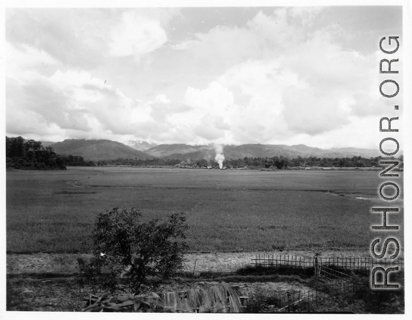 Smoke rising from distance village in Burma.  During WWII.  797th Engineer Forestry Company.