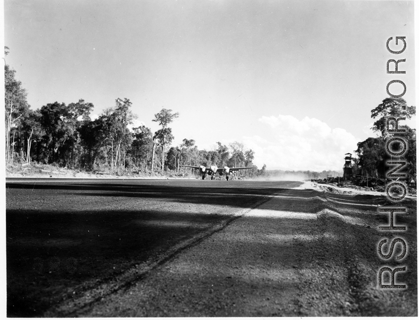 A P-38 on an airstrip in Burma.  Aircraft in Burma near the 797th Engineer Forestry Company.  During WWII.