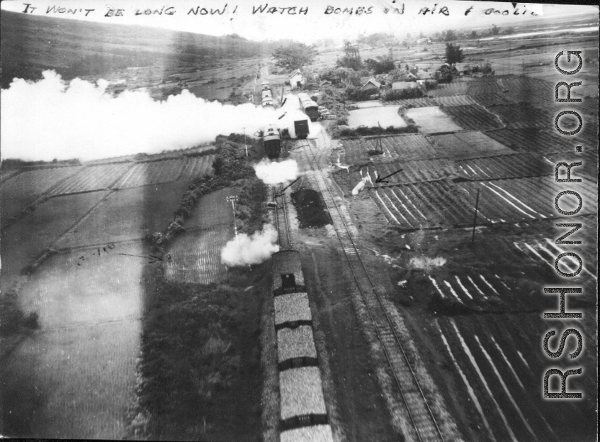 "It won't be long now! Watch bombs in air..."  This train was wiped out with low level bombs & gunfire. Note on back of the photo reads: Three track RR sliding with 17 cars and locomotive, which is destroyed, note wreckage from bomb bursts and quantity of escaping steam. 3 cars probably destroyed, more damaged. Two of track torn up by bomb bursts, hole from strafing is visible on extreme left track.  This should be Van Trai Station, French Indochina.