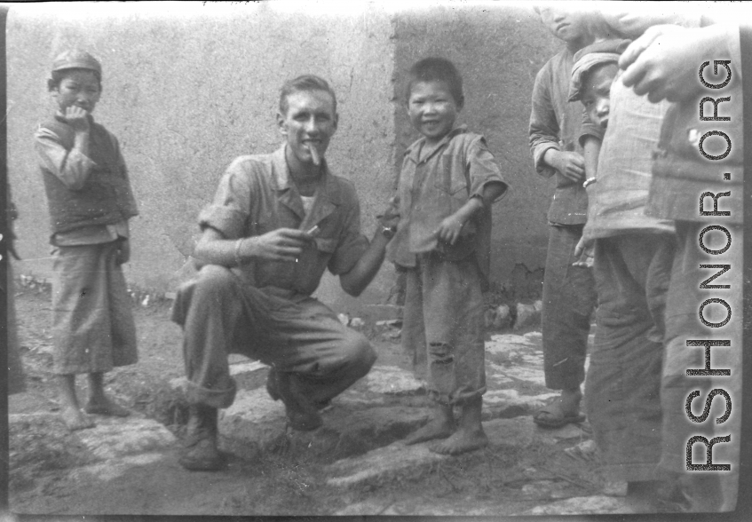 Walter L. Wegner, cigar in mouth, with children in SW China during WWII.