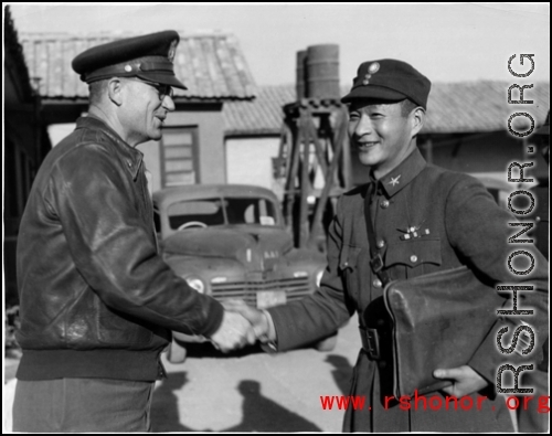 Chinese and American officers shake hands in SW China during WWII.
