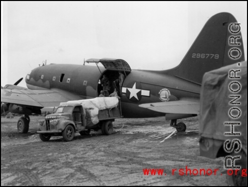 A C-46, #296779, loading or unloading cargo in the CBI during WWII.