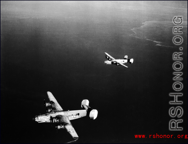 B-24 bombers in flight over water in the CBI, with "Spare Parts" on the left.  Note the shark teeth on the nose of each.