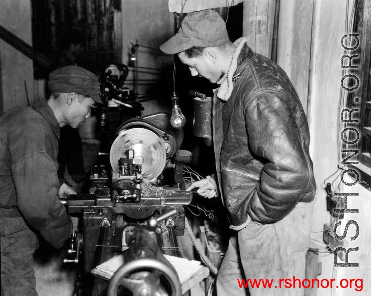 American and Chinese men work together at a lathe.  Image from U. S. Government official sources. 