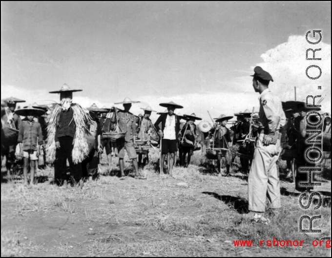 Workers in locally made hats and weather protection in China during WWII. These are most likely working on an American air base.  Official Gov. Image.