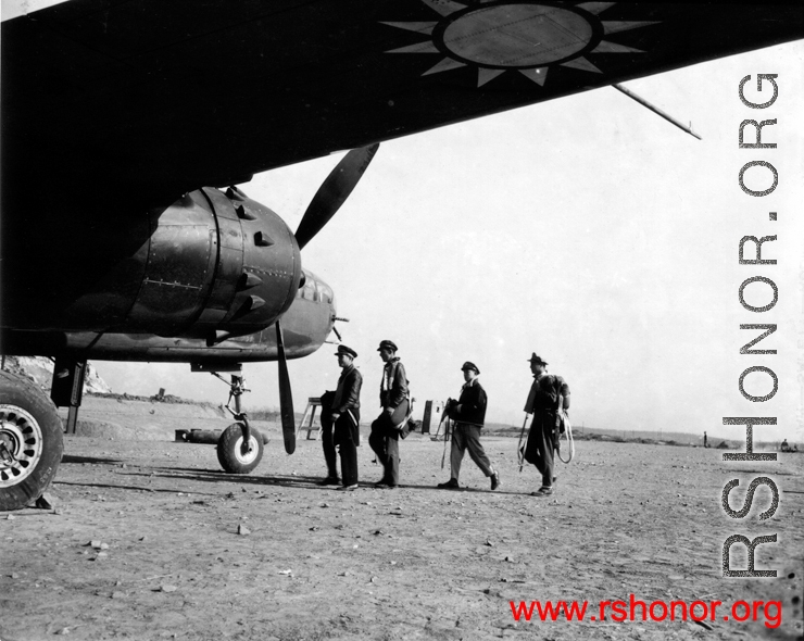 Chinese and American officers prepare for a mission on a B-25J at an unidentified base. Their Squadron (unknown) is part of the 1st Bombardment Group, Chinese-American Composite Wing (CACW).