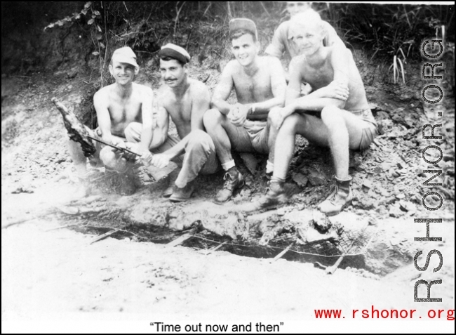 "Time out now and then"  The boys roasting meat over a fire pit.  Rex G. Gouger is on the far right.