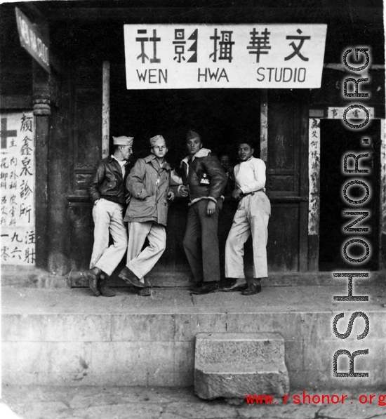 American GIs and Chinese man stand in front of a photo shop, the Wen Hwa Studio (文化摄影社), in China during WWII.