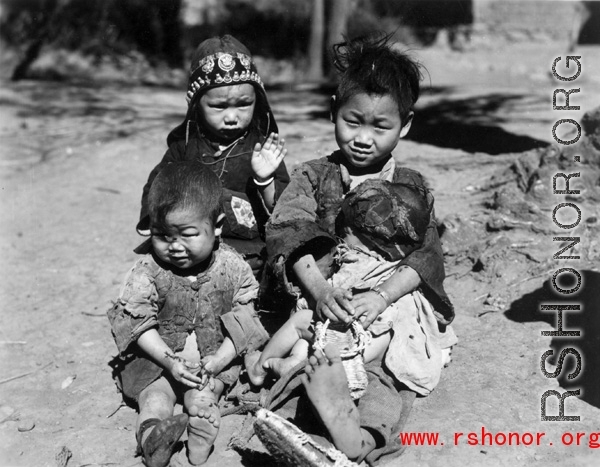 Local people in China during WWII: And older child takes care of younger children. During WWII.