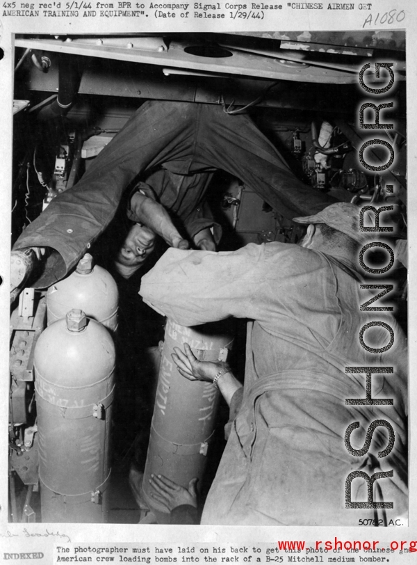 Chinese American Composite Wing (CACW) --"CHINESE AIRMEN GET AMERICAN TRAINING AND EQUIPMENT." The photographer must have laid on his back to get this photo of the Chinese and American crew loading bombs into the rack of a B-25 Mitchell medium bomber.  During WWII in China.  Images courtesy of Tony Strotman.