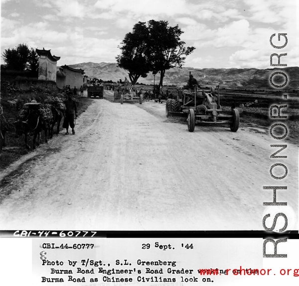 September 29, 1944, Burma Road Engineer's road grader working on the Burma Road and Chinese civilians look on.