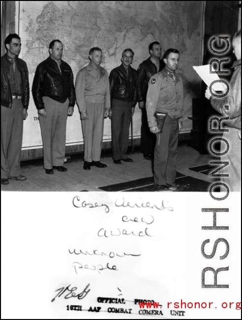 "Casey Vincent crew award." During WWII. Clinton D. "Casey" Vincent is the tall one in back, second from the right.  Far left is probably  Lt. Col. Grattan "Grant" Mahony (commander of the 76th Fighter Squadron).