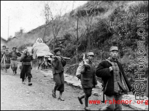 Refugees carry loved one while fleeing around either Liuzhou or Guilin during the evacuation before the Japanese Ichigo advance in 1944, in Guangxi province.
