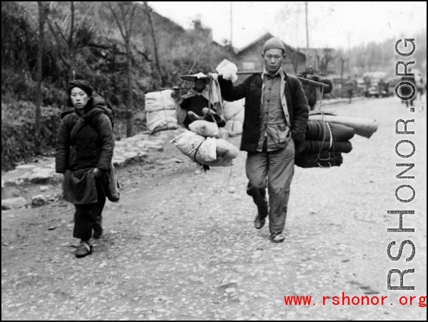 Refugees fleeing around either Liuzhou or Guilin carry possessions during the evacuation before the Japanese Ichigo advance in 1944, in Guangxi province.
