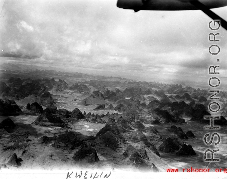 "Kweilin in aerial photo (land of a thousand breasts)."  Flying over distinct karst formations in Guangxi province, near Guilin (Kweilin), in China during WWII.
