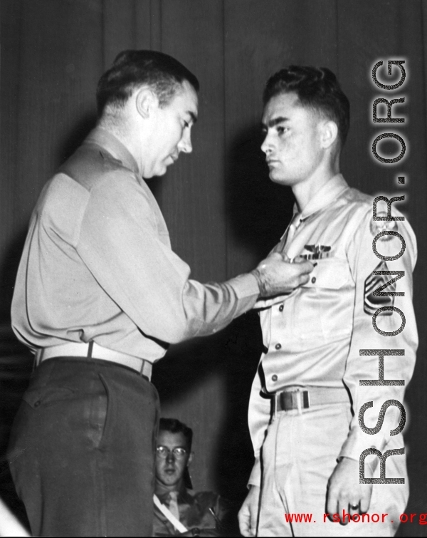 Tech. Sgt. Ora W. Seal, son of Mr. and Mrs. W. h. Seal of Fruita, is shown receiving athe Distinguished Flying Cross and the Air Medal from Lt. Col. John. E. Carmack, post executive officer, at a ceremony held recently at Truax Field, Madison, Wisconsin.