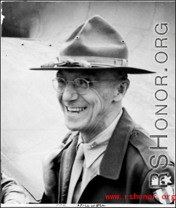 Joseph Stilwell smiles in front of an airplane in the CBI during WWII.