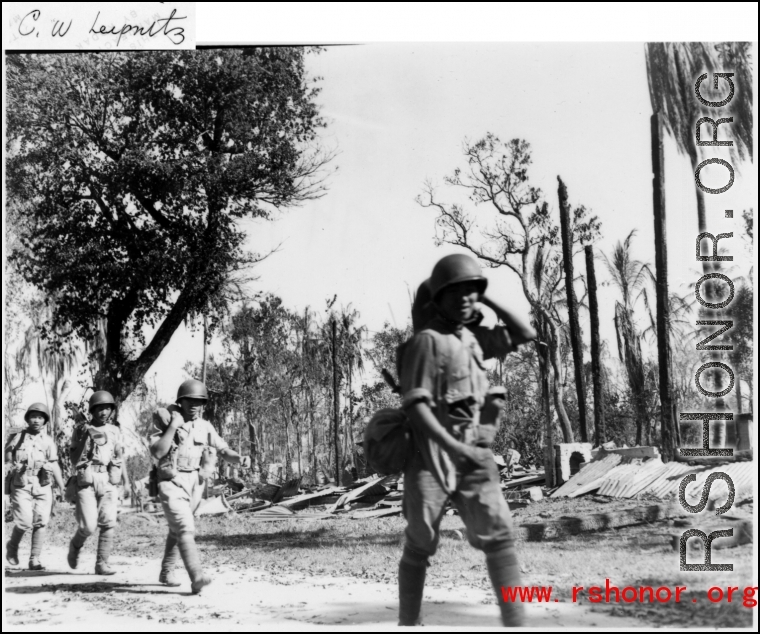 Chinese troops on the move in a wrecked area of Burma, during WWII.  Photo by C. W. Leipnitz.
