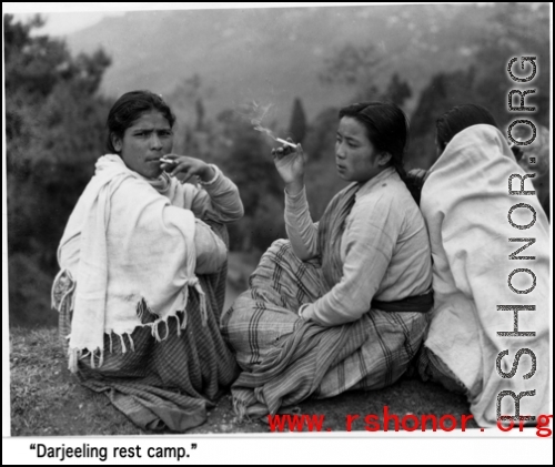 Three ladies smoke on a cold day at the rest camp at Darjeeling. During WWII.
