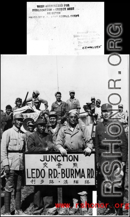 Soldiers pose at junction of Burma & Ledo Roads during WWII.