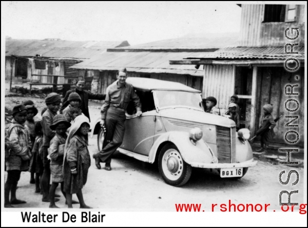 GI leans against car in the CBI during WWII. Walter De Blair.