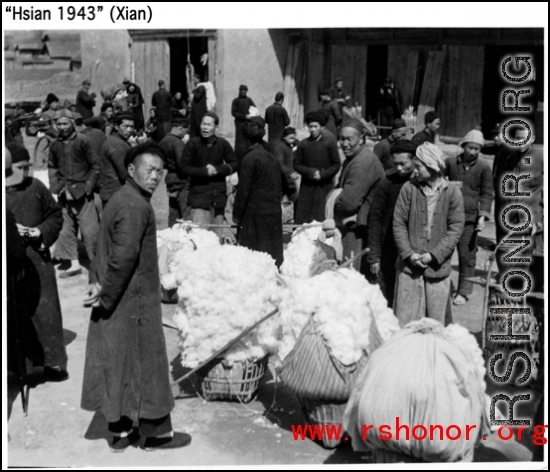 Cotton buyers and sellers in Xi'an (Hsian) in 1943 negotiate their trades.