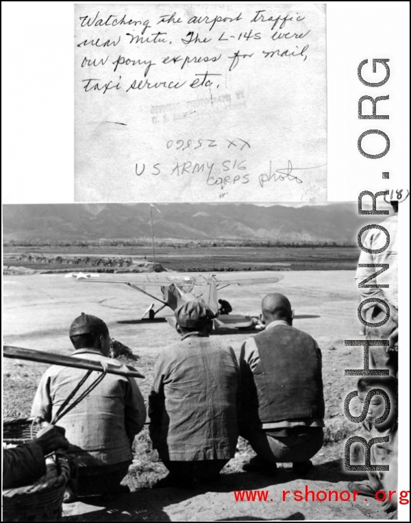 Three Chinese men observe a parked L-14 . Near Mitu, in the CBI during WWII.  U. S. Army Signal Corps Photo.