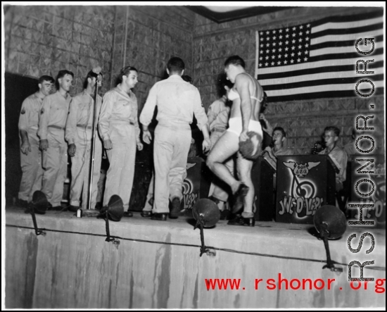 Acts change places--including a cross-dressing GI--while the band Jive-o-Lieps plays music in the CBI during WWII. 54th Air Service Group.