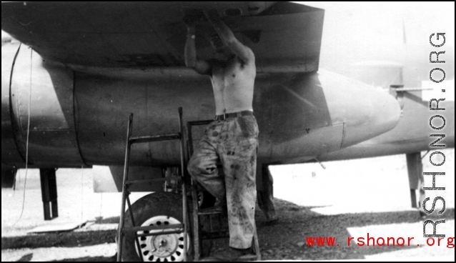 George Butsika working under wing of B-25. Yangkai, May 1944.  From the collection of Frank Bates.