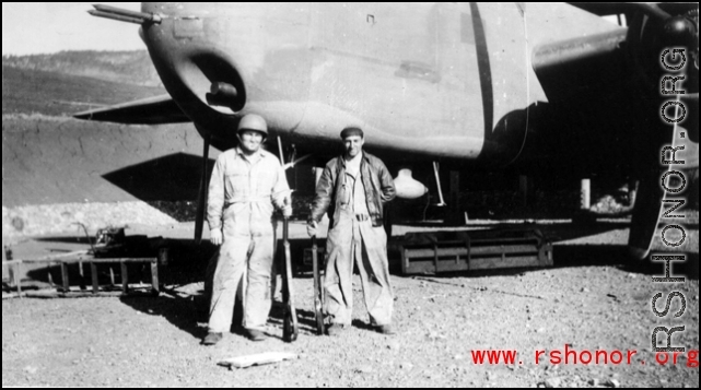 John Carberry and Claude Darni in front of B-25 and holding rifles in Yangkai, Spring 1944.
