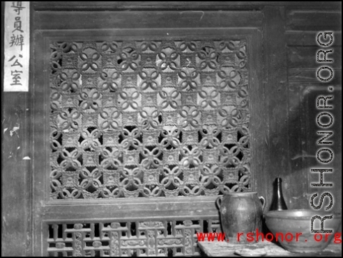 A carved wooden door screen in China. During WWII.  From the collection of Frank Bates.
