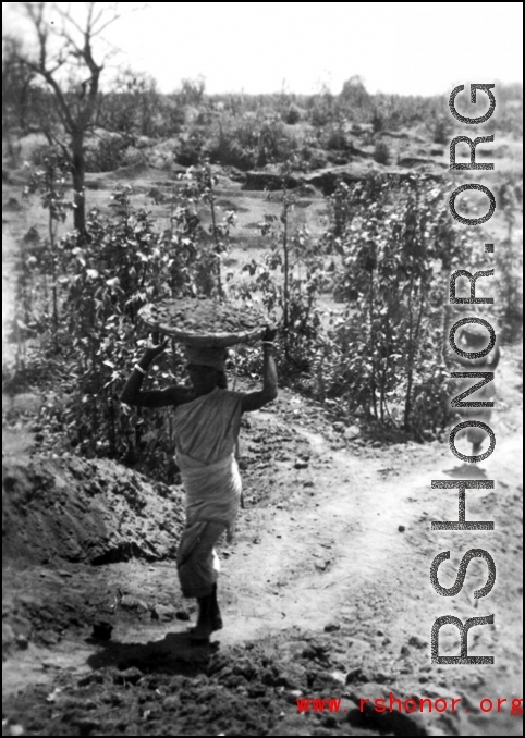 Indian woman "Hauling dirt for 72's Revetment, Chaukulia, India 1943."